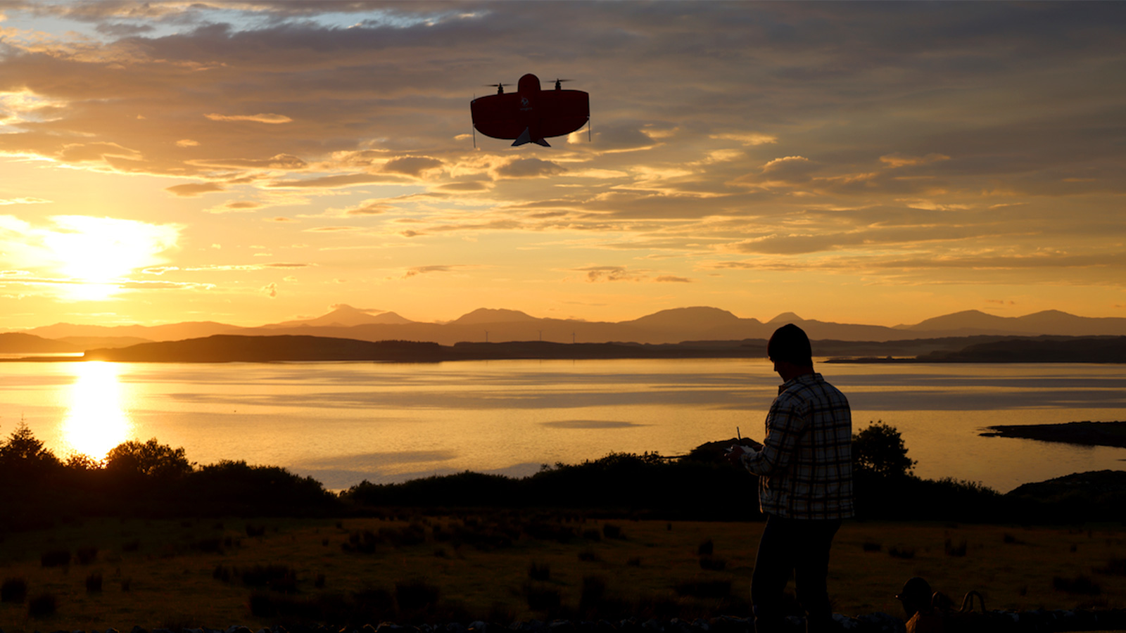 WingtraOne drone taking off silhouetted against a beautiful sunset